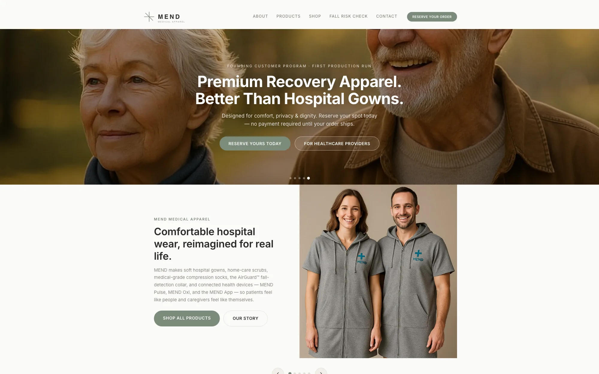The MEND Medical Wear homepage: a smiling older couple photographed outdoors in warm light, overlaid with the headline “Premium Recovery Apparel. Better Than Hospital Gowns.” Below it, two people wear grey zip-front MEND gowns beside the heading “Comfortable hospital wear, reimagined for real life.”